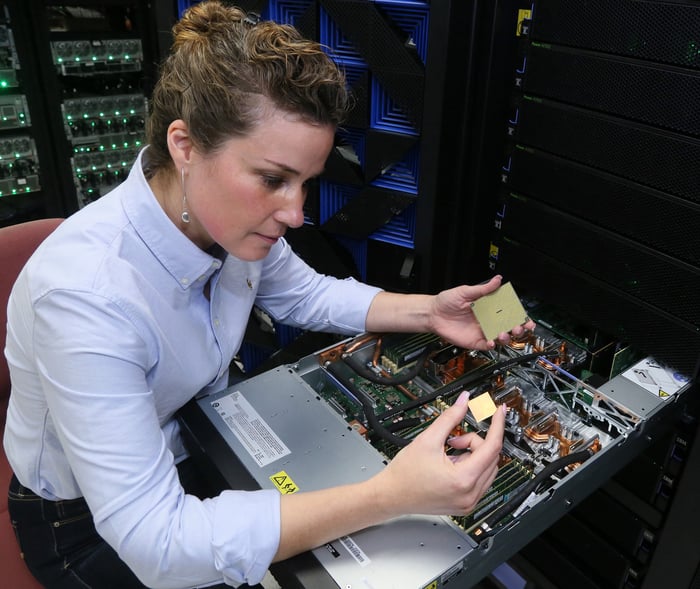 A woman holding IBM's POWER9 processor.