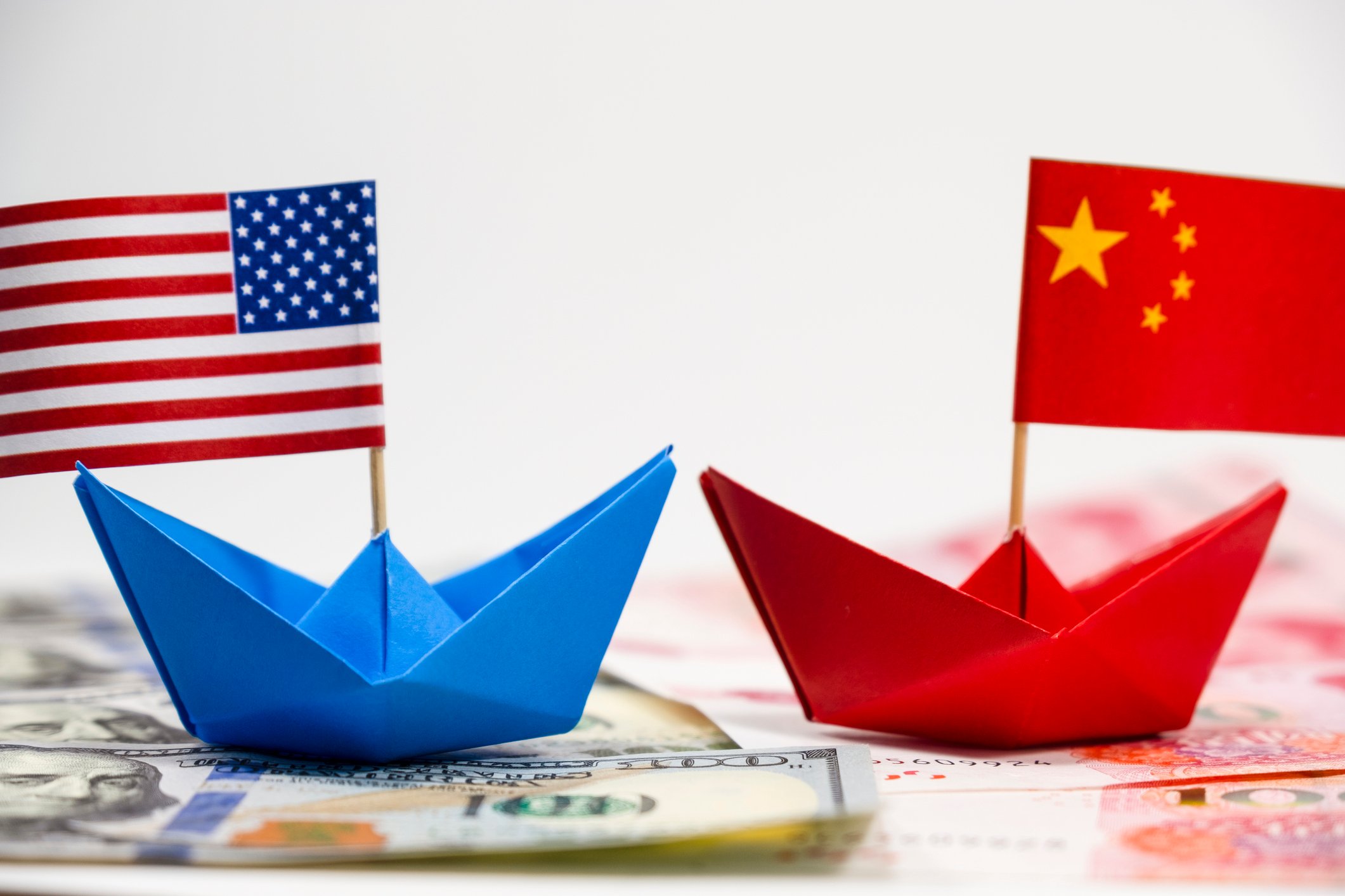 Two paper boats adorned with the American and Chinese flags.
