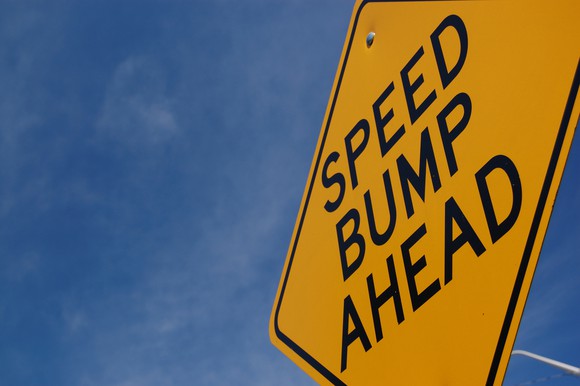 A sign that says "speed bump ahead."