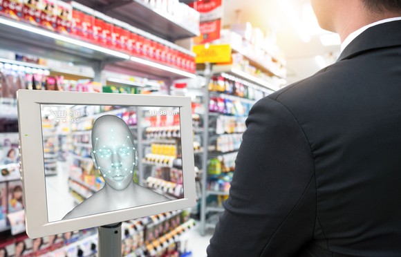 A shopper pays with a facial-recognition tablet.