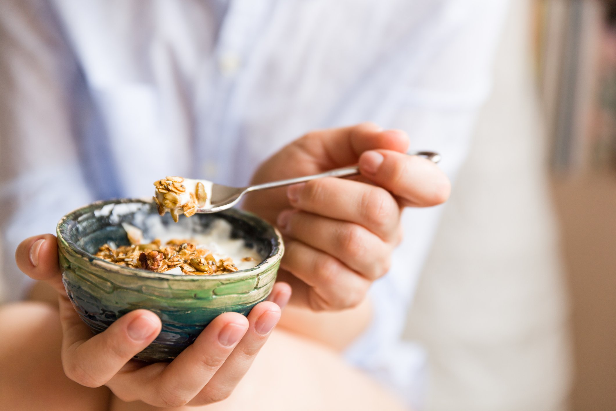 Close-up of a bowl of muesli and yogurt at breakfast.
