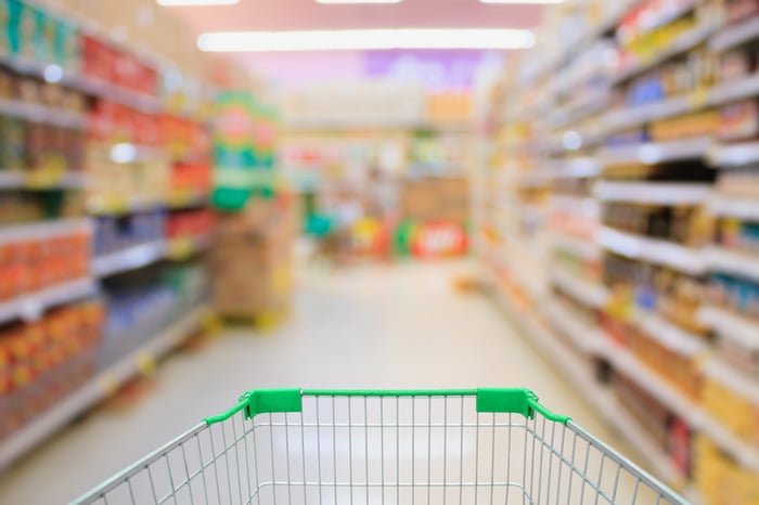 A grocery store aisle from the perspective of someone pushing a shopping cart.