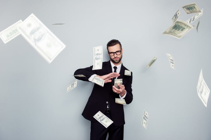 Guy in a suit making it rain money.