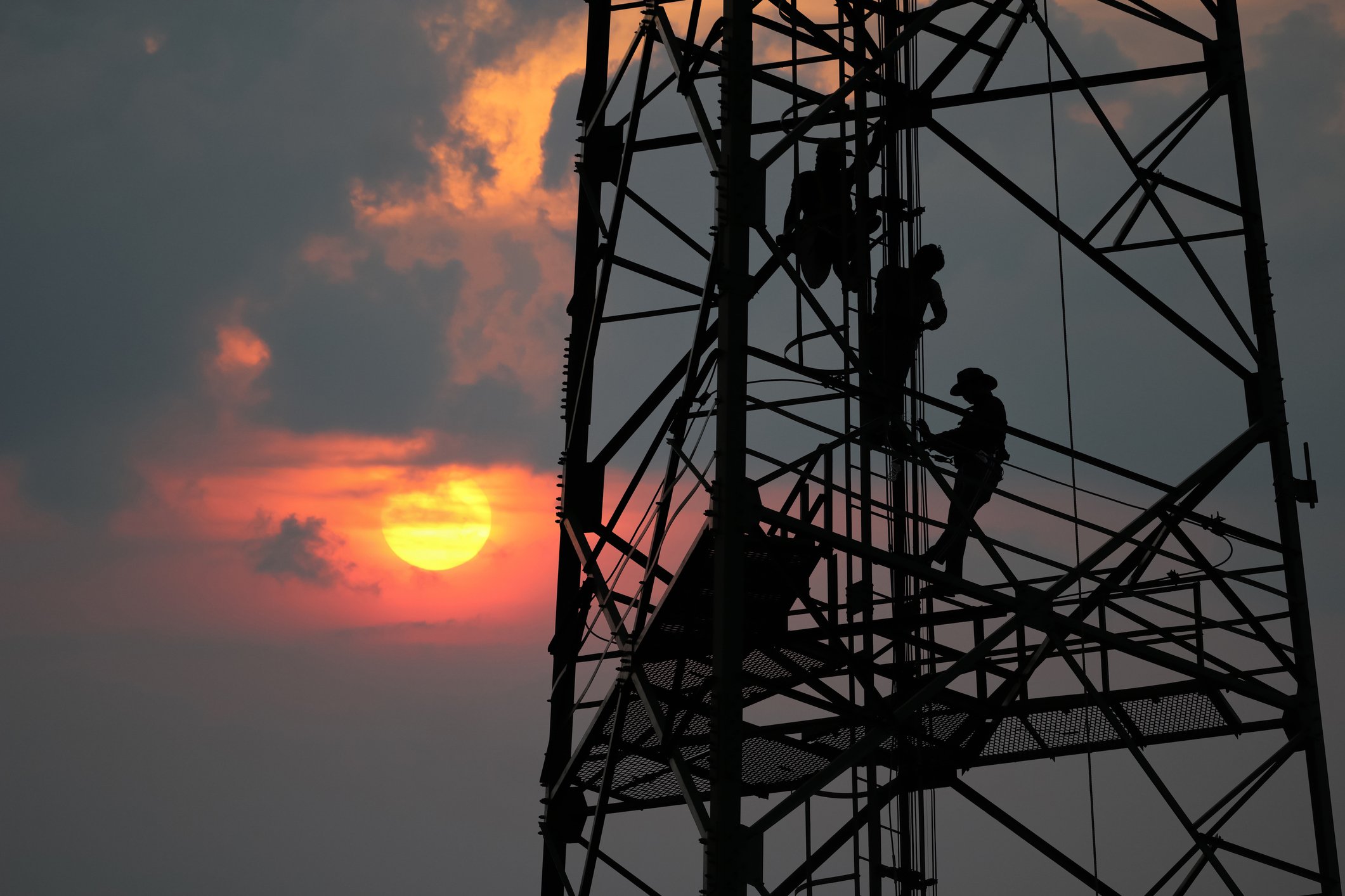 Men working on a communications tower.