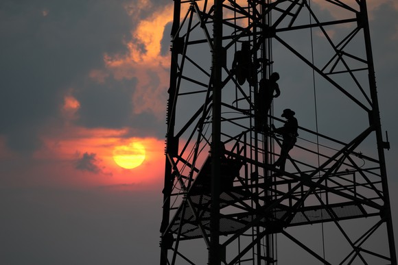 Men working on a communications tower.
