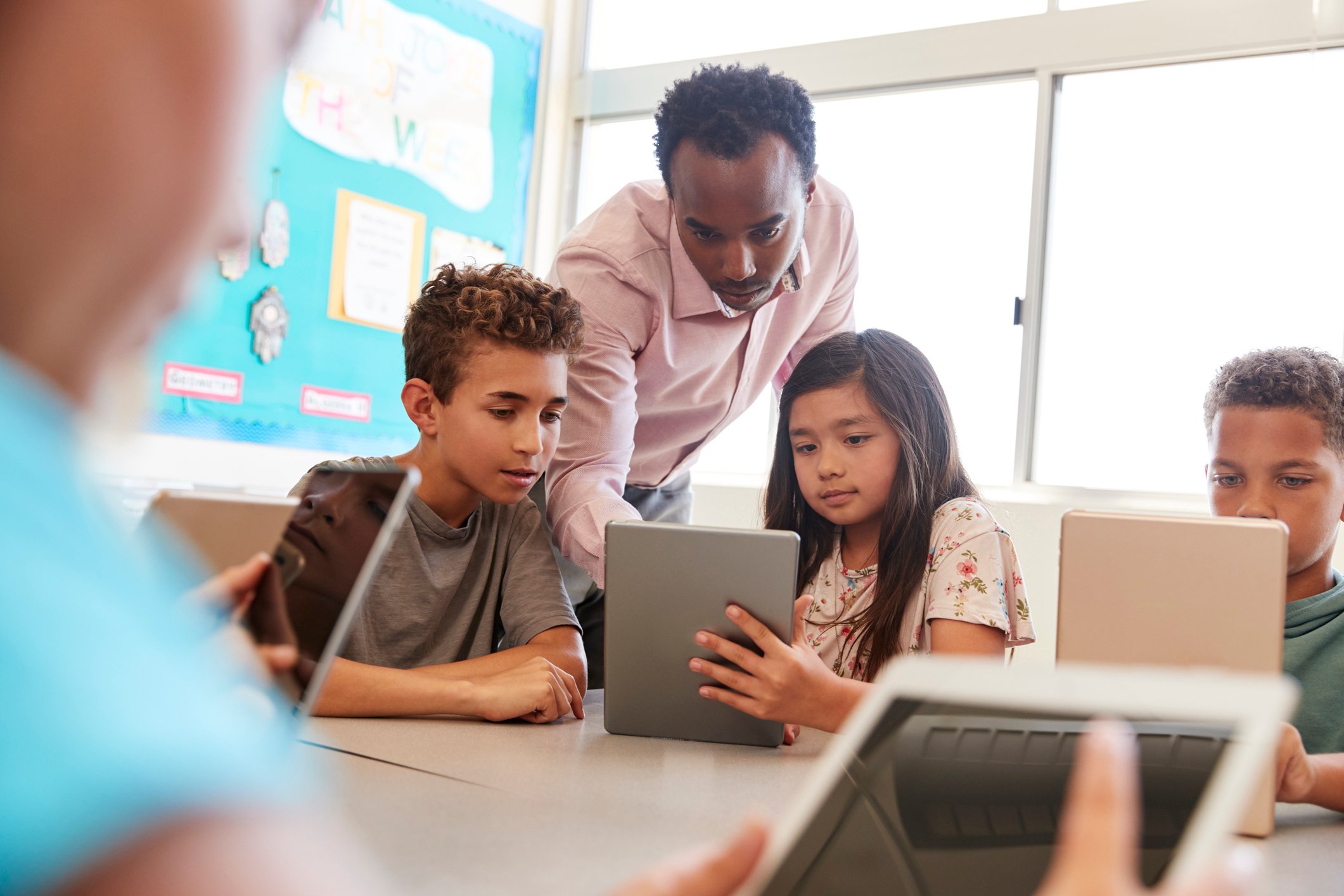 Kids using tablets in a classroom. 