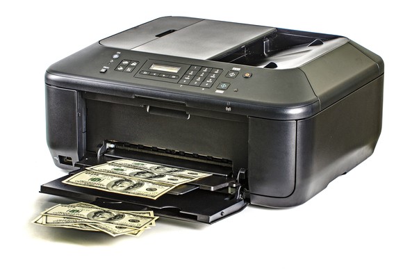 A printer spitting out sheets full of hundred-dollar bills.