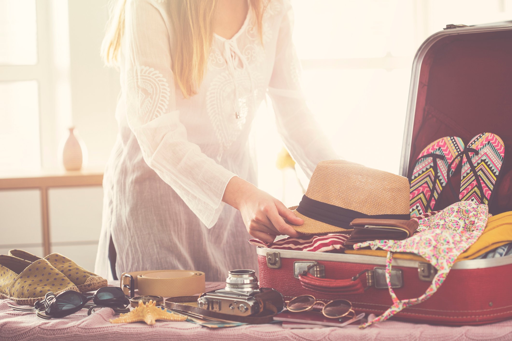 A woman packing a suitcase
