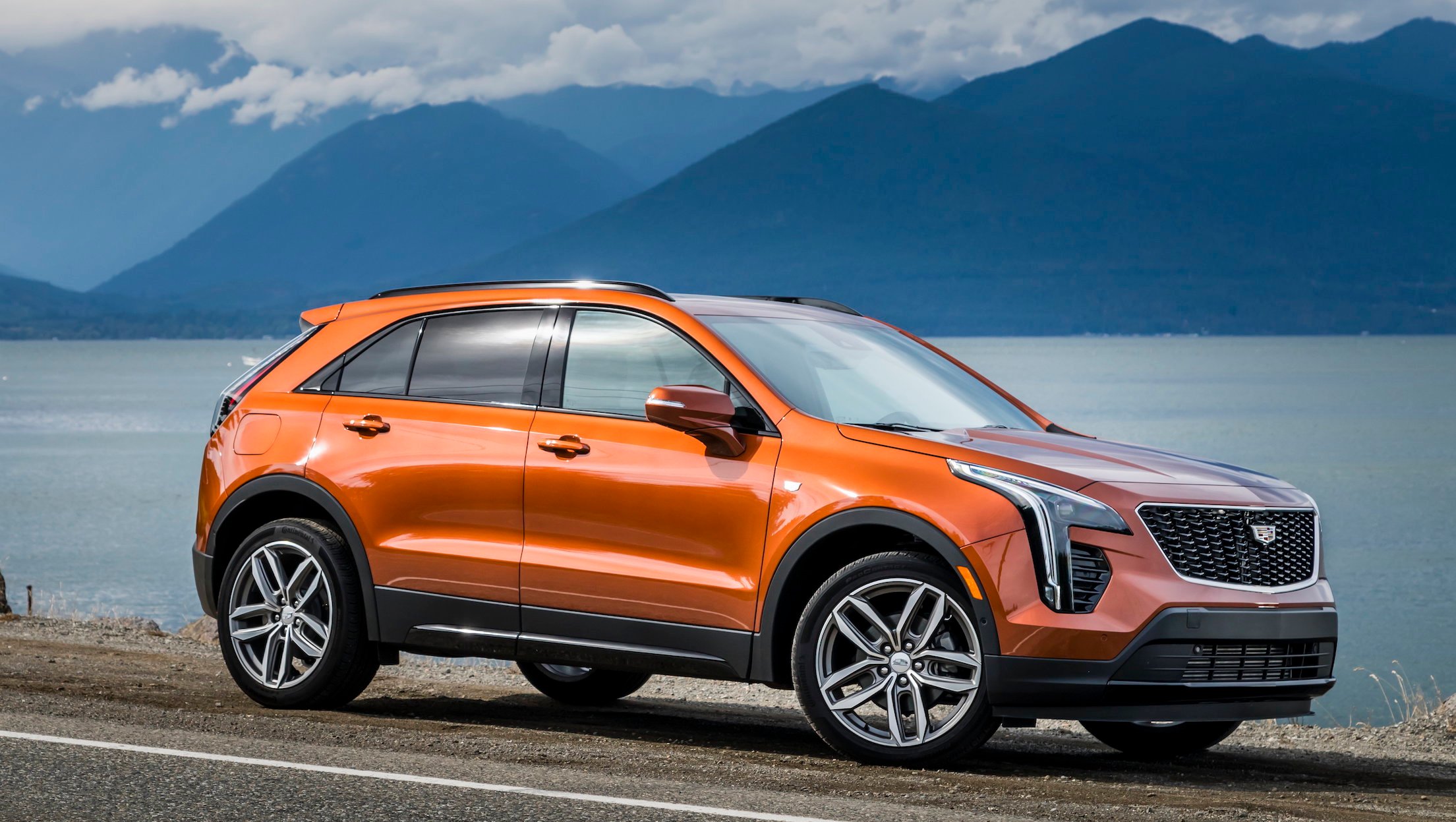 An orange 2019 Cadillac XT4, an upscale compact crossover SUV. 