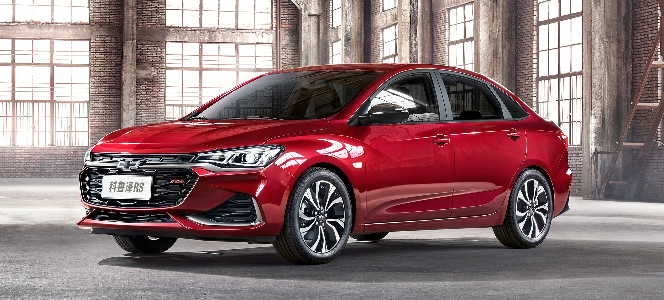 A red Chevrolet Monza, a compact sedan.