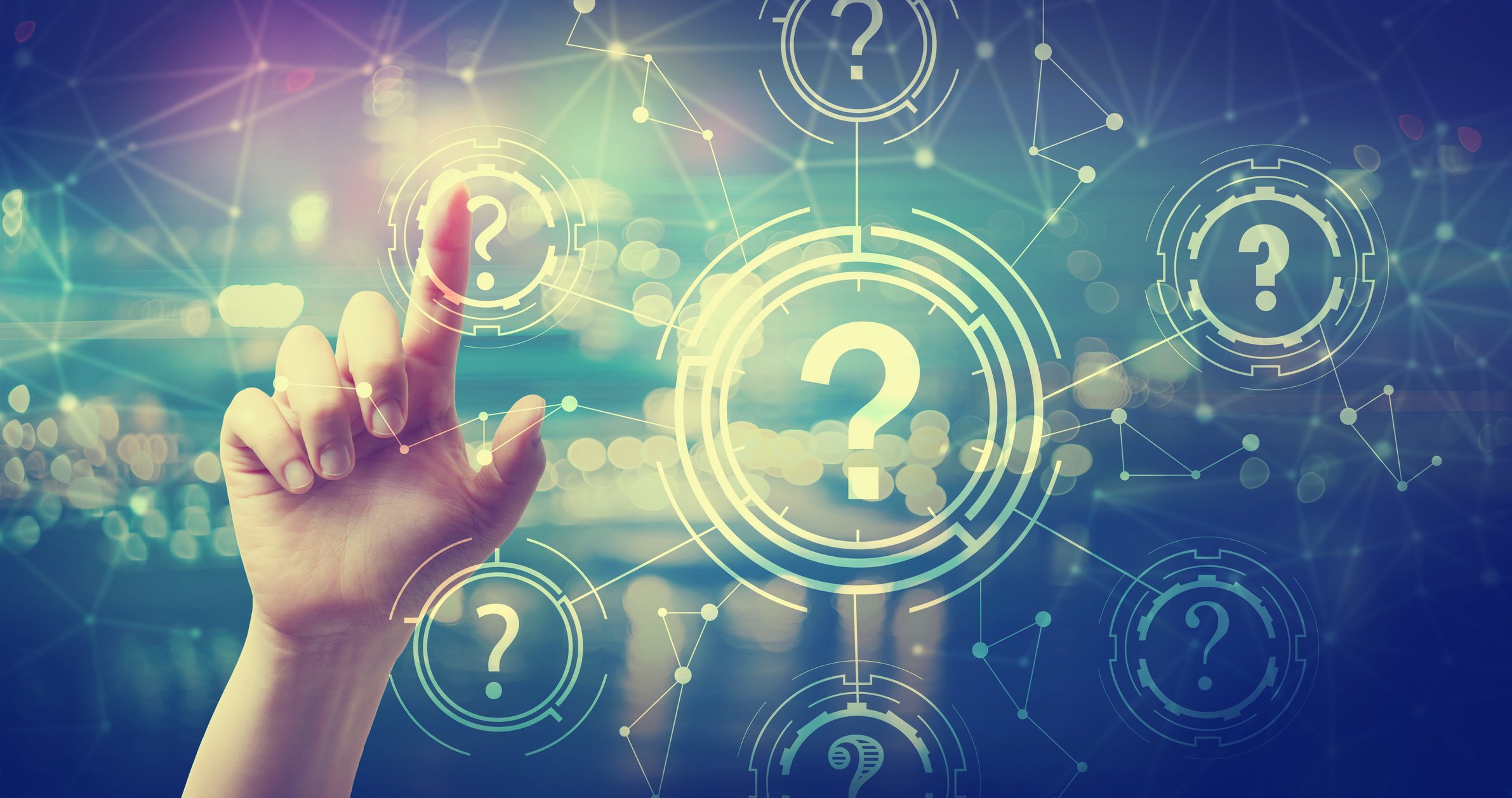 A finger touches one of several question marks on a digital display.