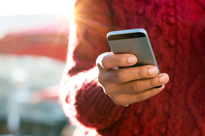 A hand holding a smartphone