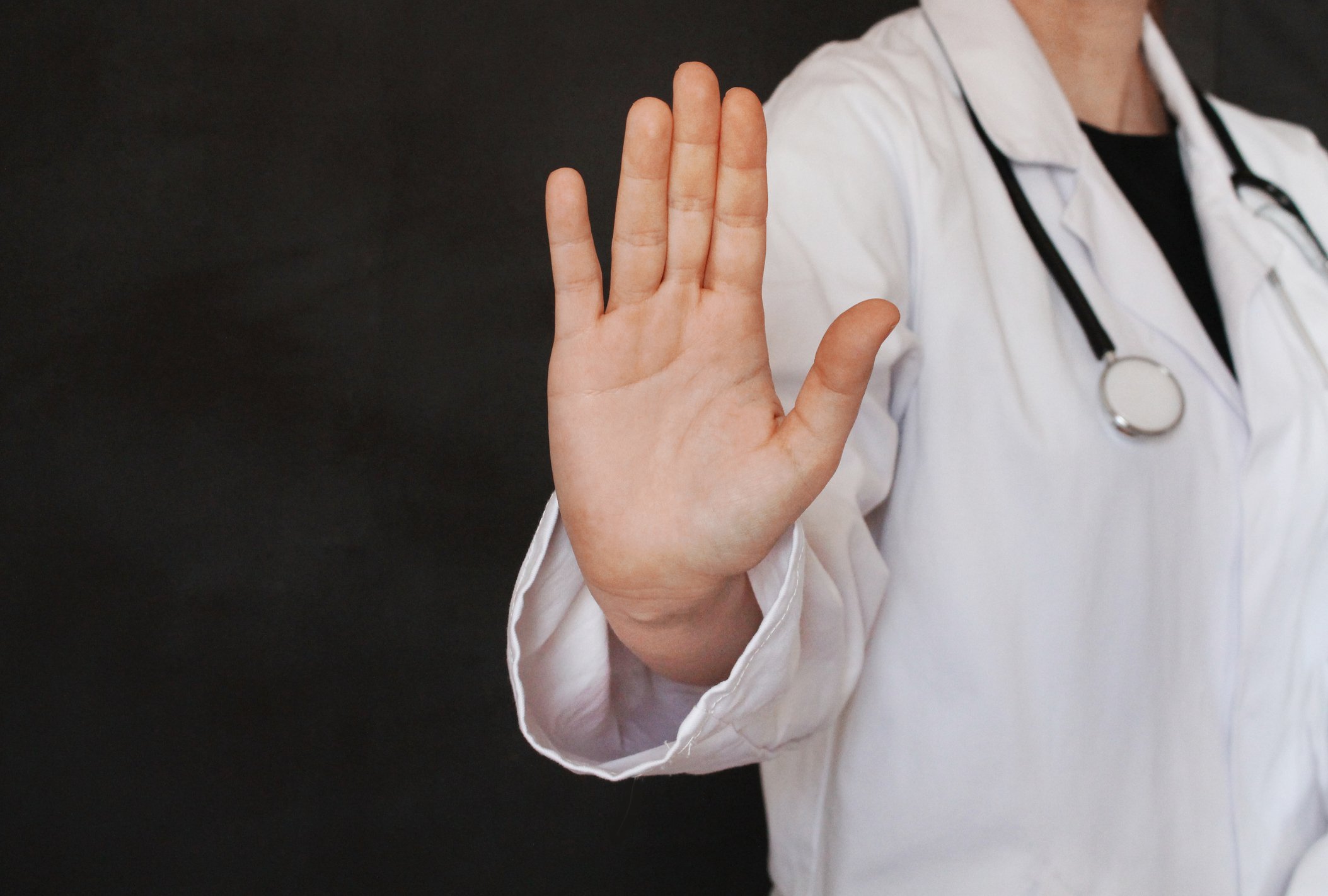 Doctor holding up hand as if to stop something