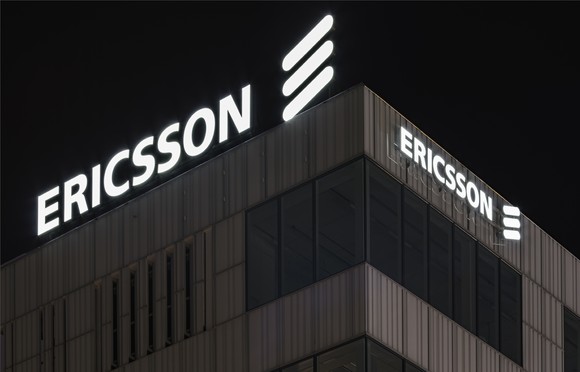 One corner of LM Ericsson's logo-adorned Stockholm headquarters, shot at night.