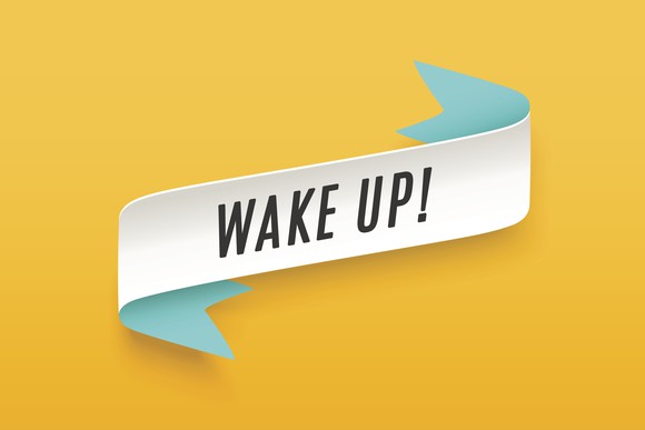 The words wake up are printed on a white strip against a yellow background. 