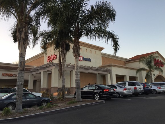 A shopping center with palm trees owned by Retail Opportunity Investments.