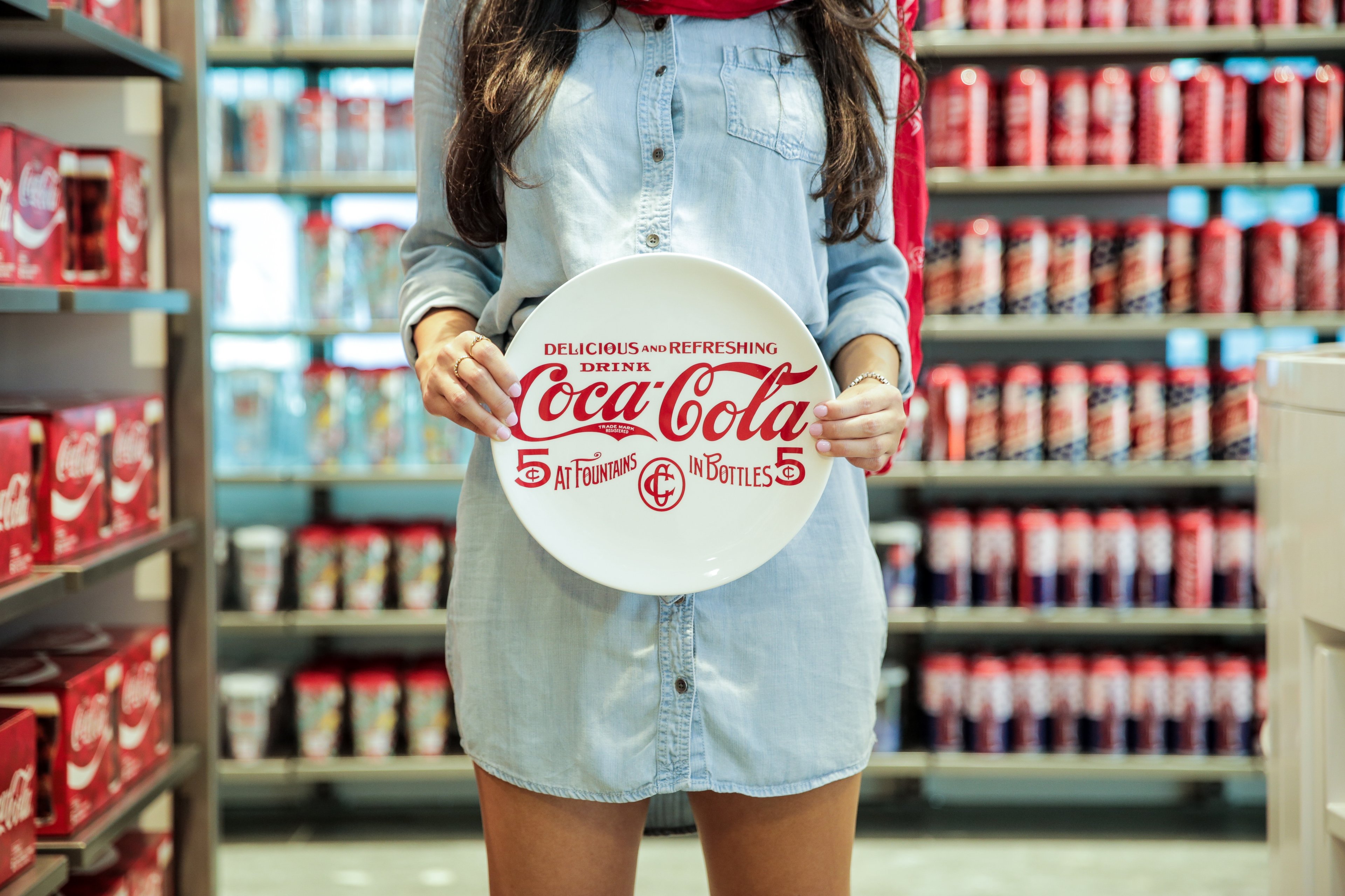 A woman holds a Coca-Cola plate at the Coca-Cola Store in Orlando.