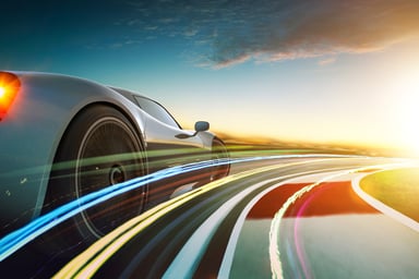 grey sport car drving at a fast speed