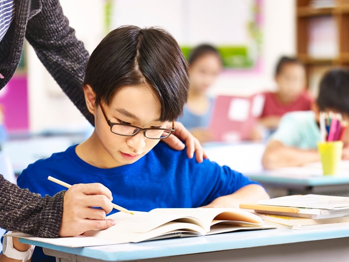 A child receiving tutoring help.