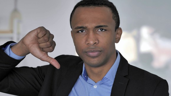 Man in business suit with thumbs down