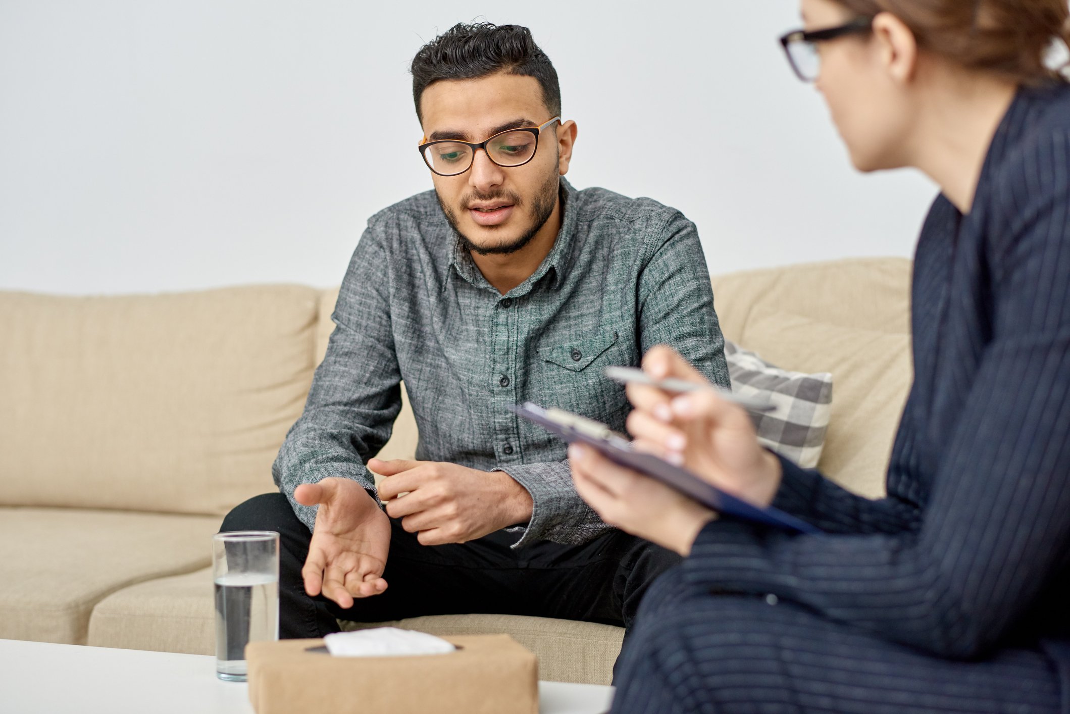 Psychiatrist talking to a patient on a couch