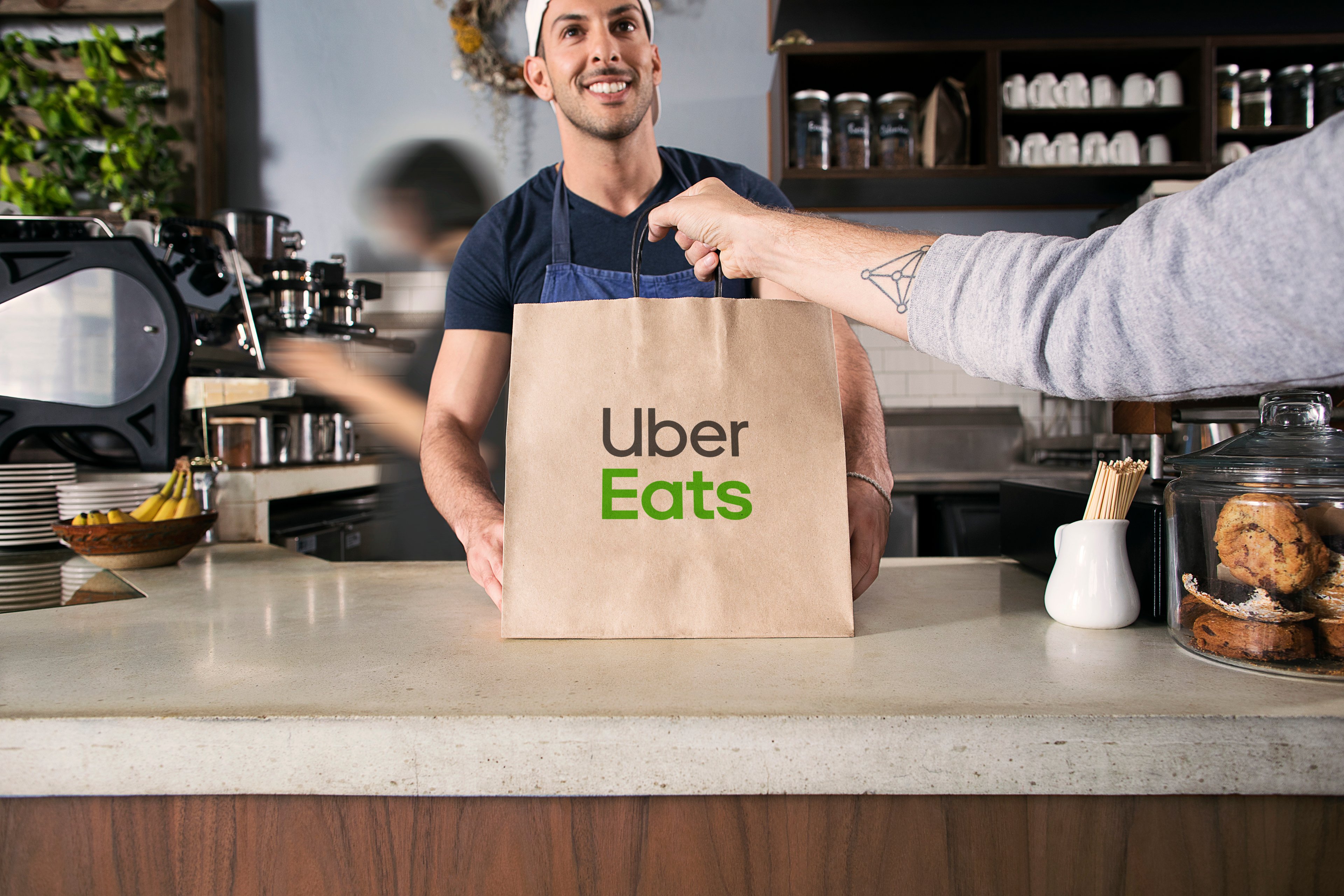 An Uber Eats courier picks up a meal.