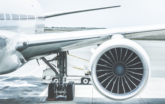 Detail of an airplane engine and wing at a terminal gate