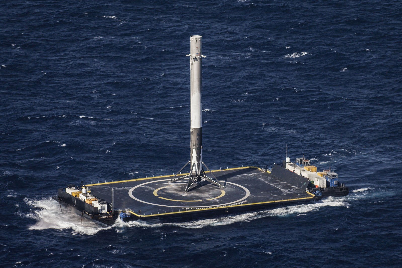 A SpaceX rocket sitting on a platform in the occean