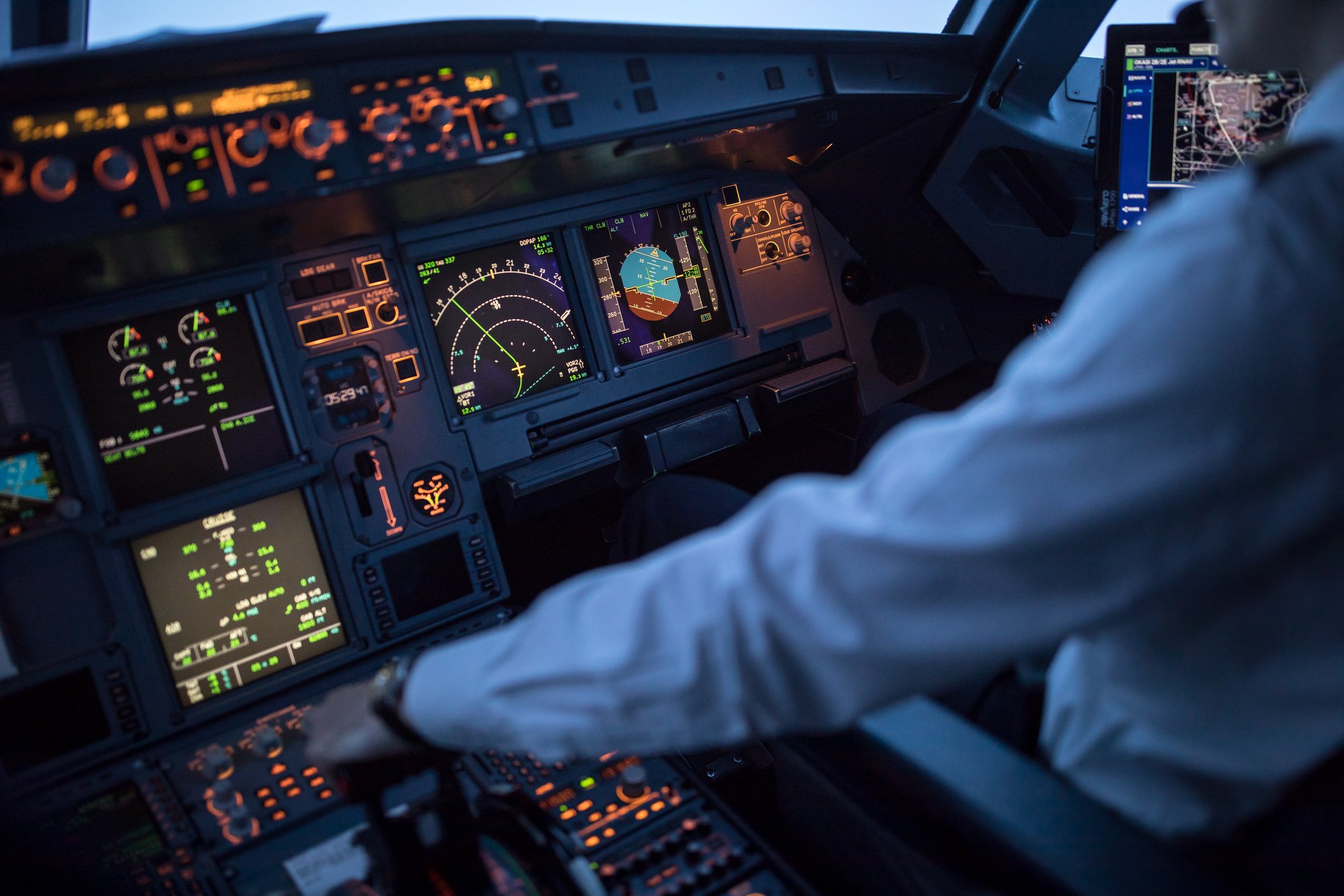 A pilot reviews his navigation instruments in the cockpit.