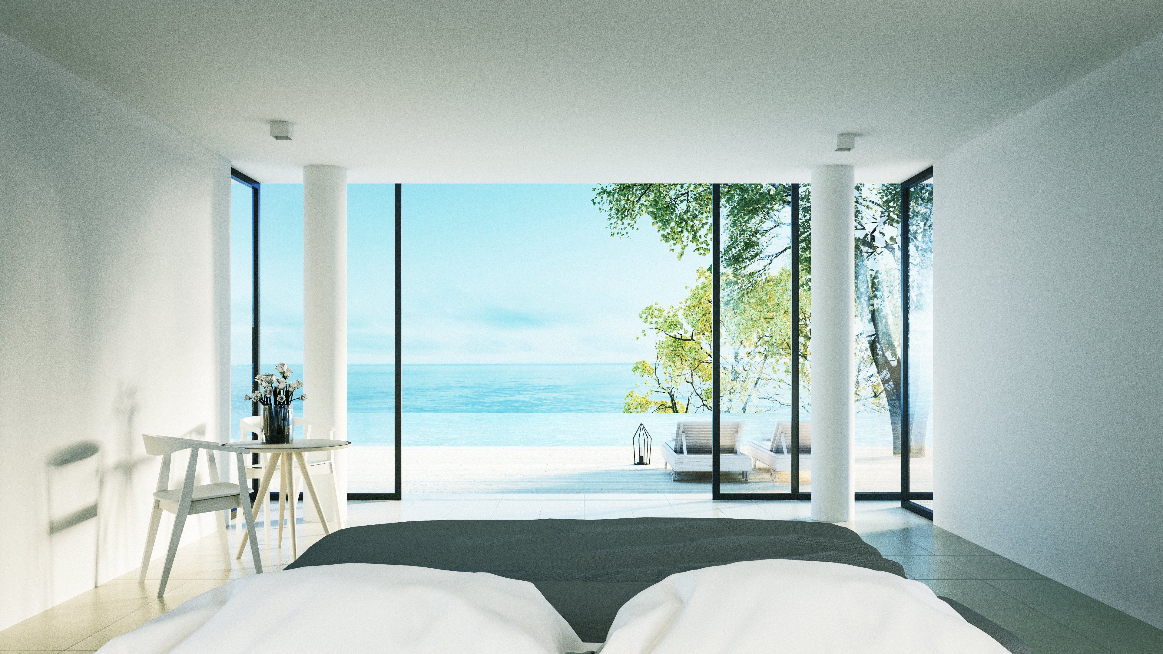 Minimalist hotel room overlooking the sea.