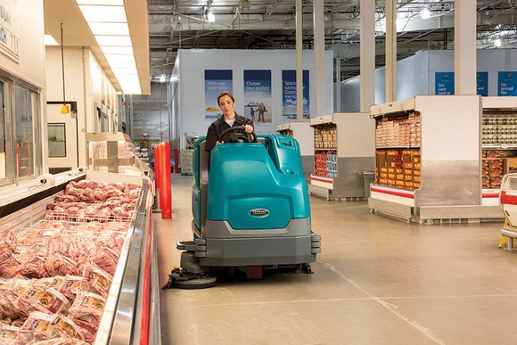 A floor scrubber at work in a grocery store.