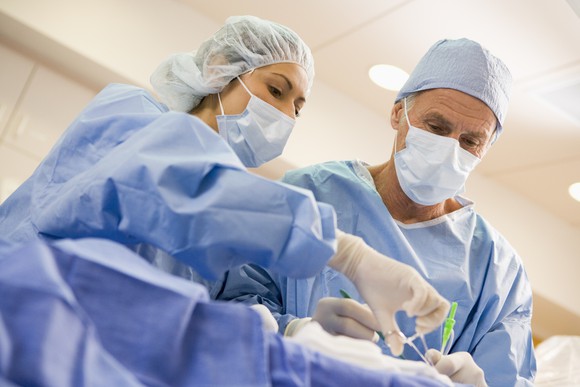 Doctors with scrubs on performing surgery