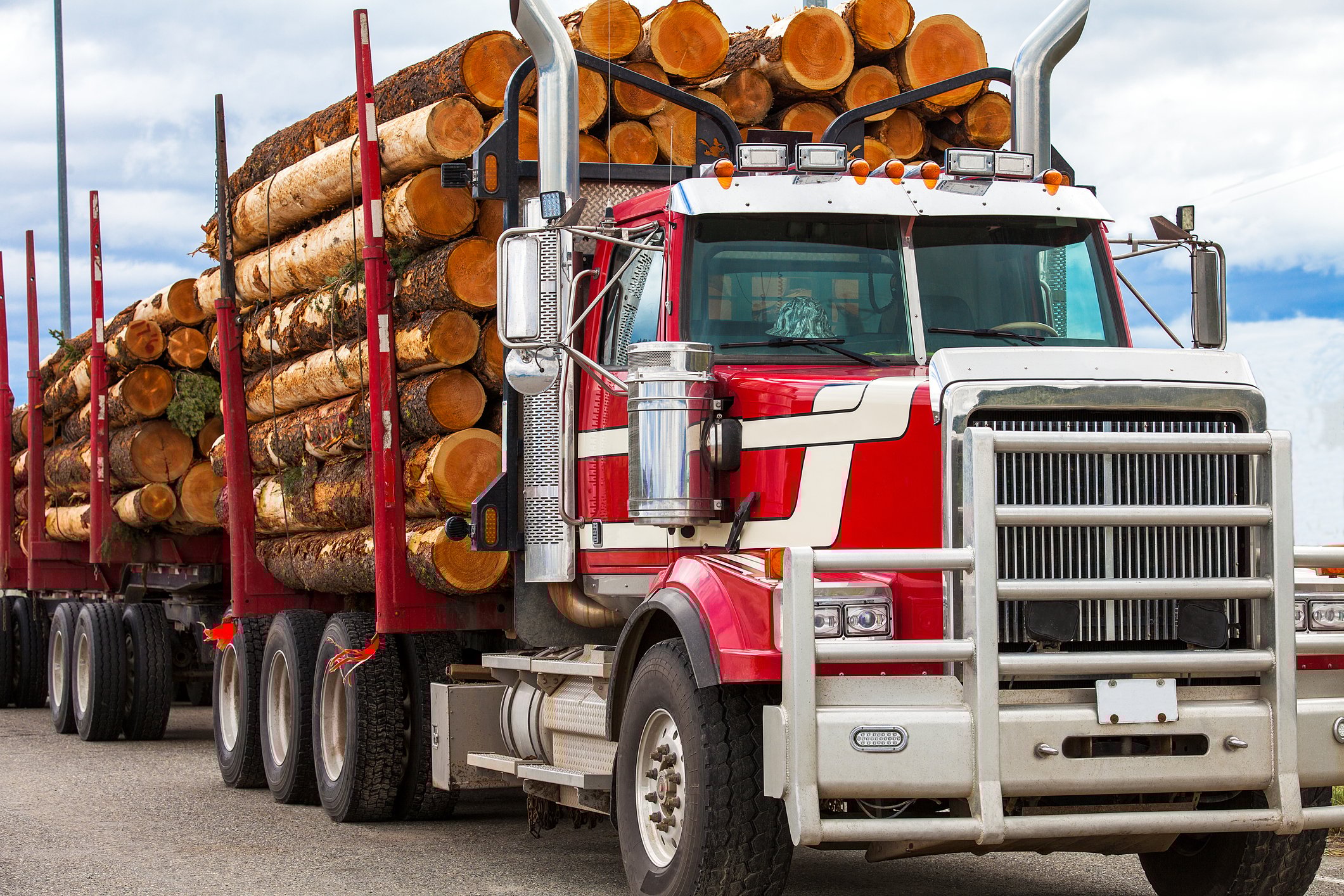 Truck hauling logs from a job site. 