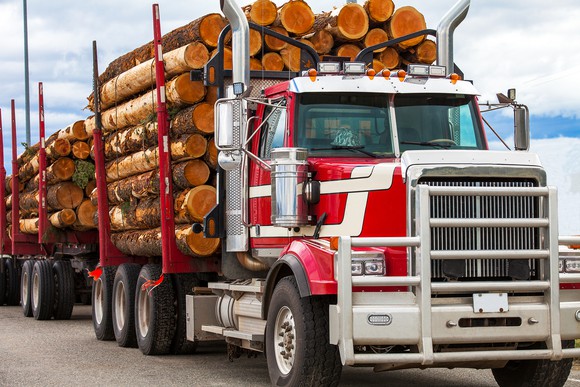 Truck hauling logs from a job site. 