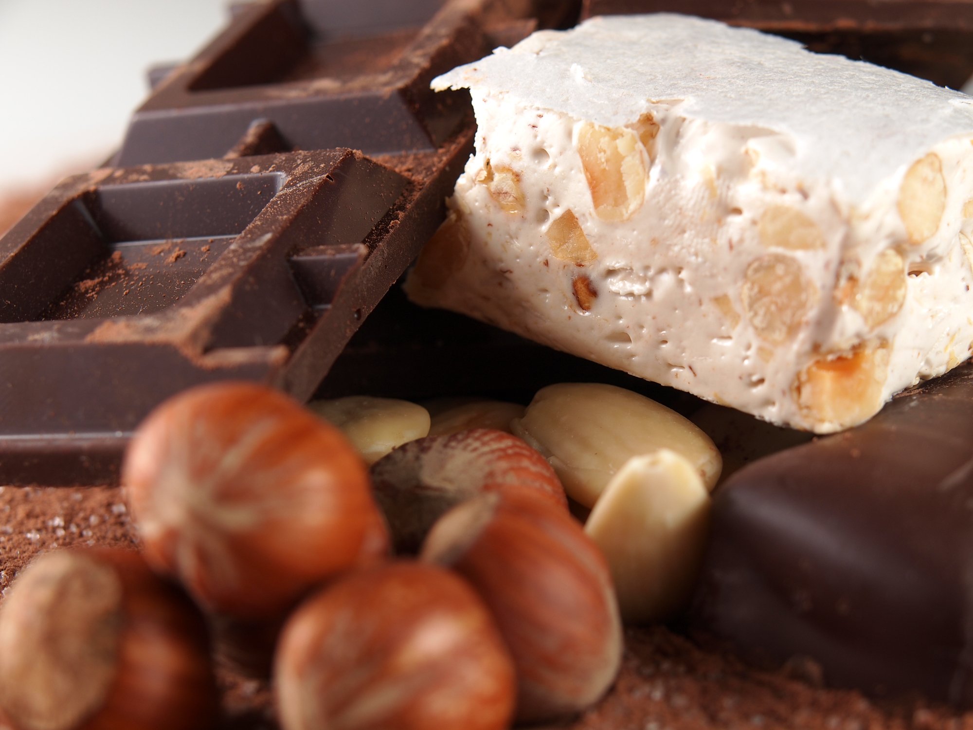 A close-up of chocolate bars and hazelnuts