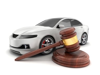 White car next to an auctioneer's gavel
