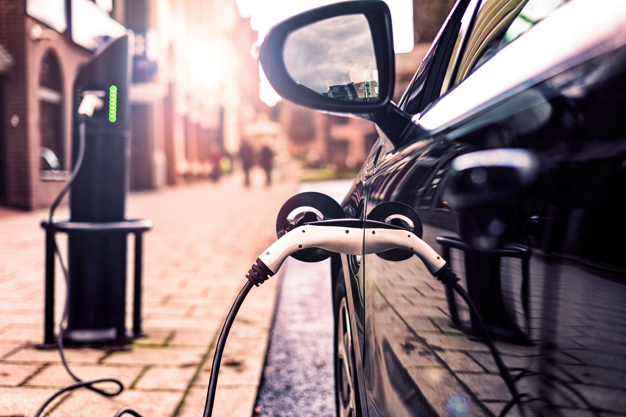 An electric car charges on a U.K. street