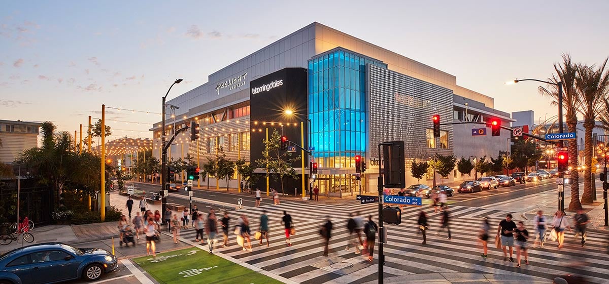 People crossing an intersection in front of the Santa Monica Place mall.