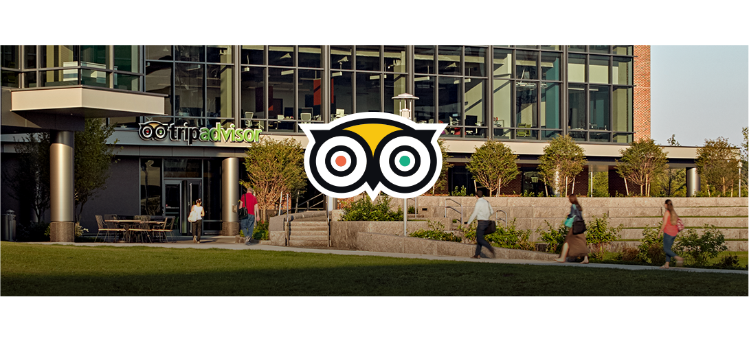 Building with TripAdvisor logo above the entrance and people walking toward it.