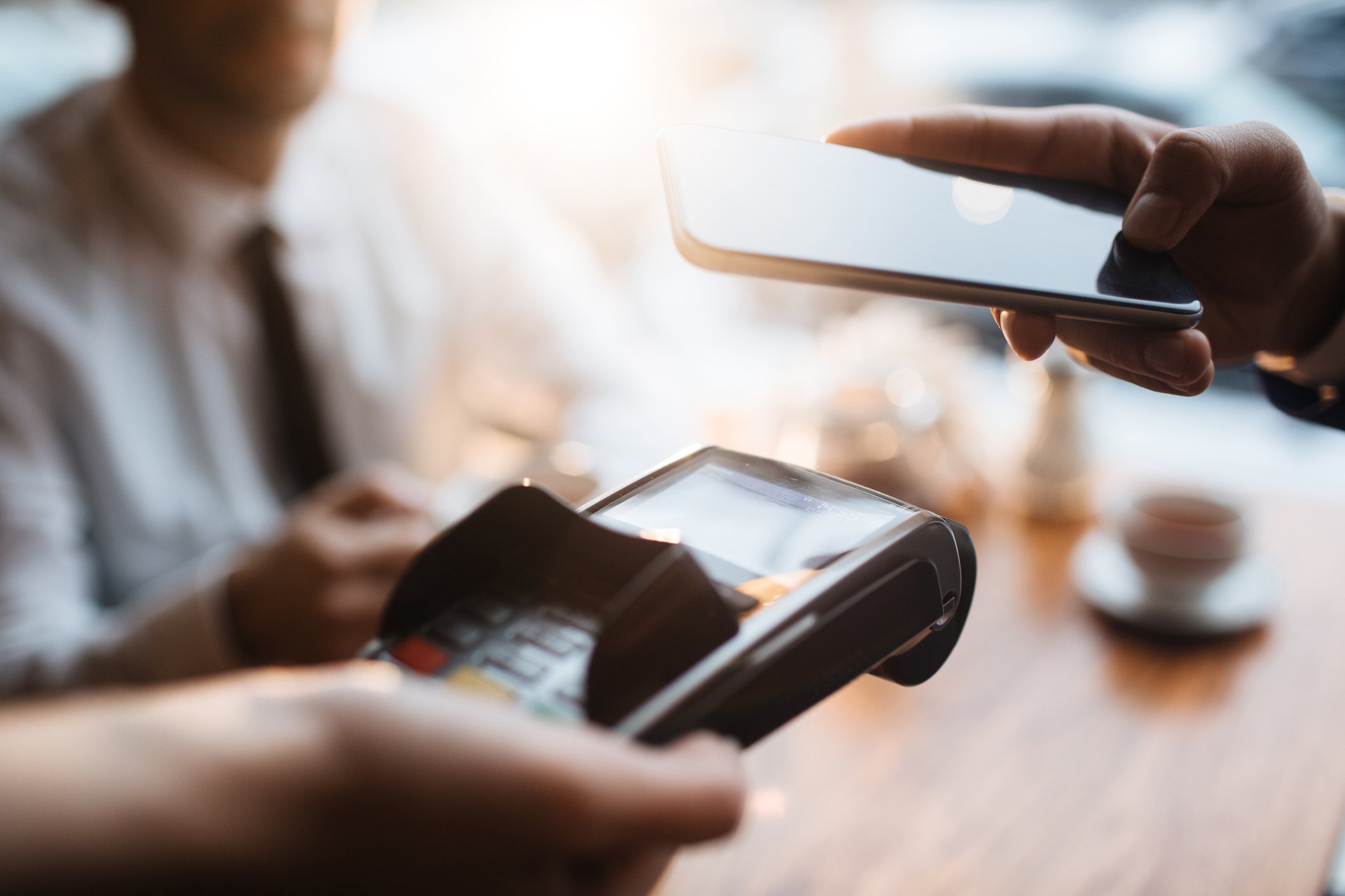A person making a mobile payment using their phone.
