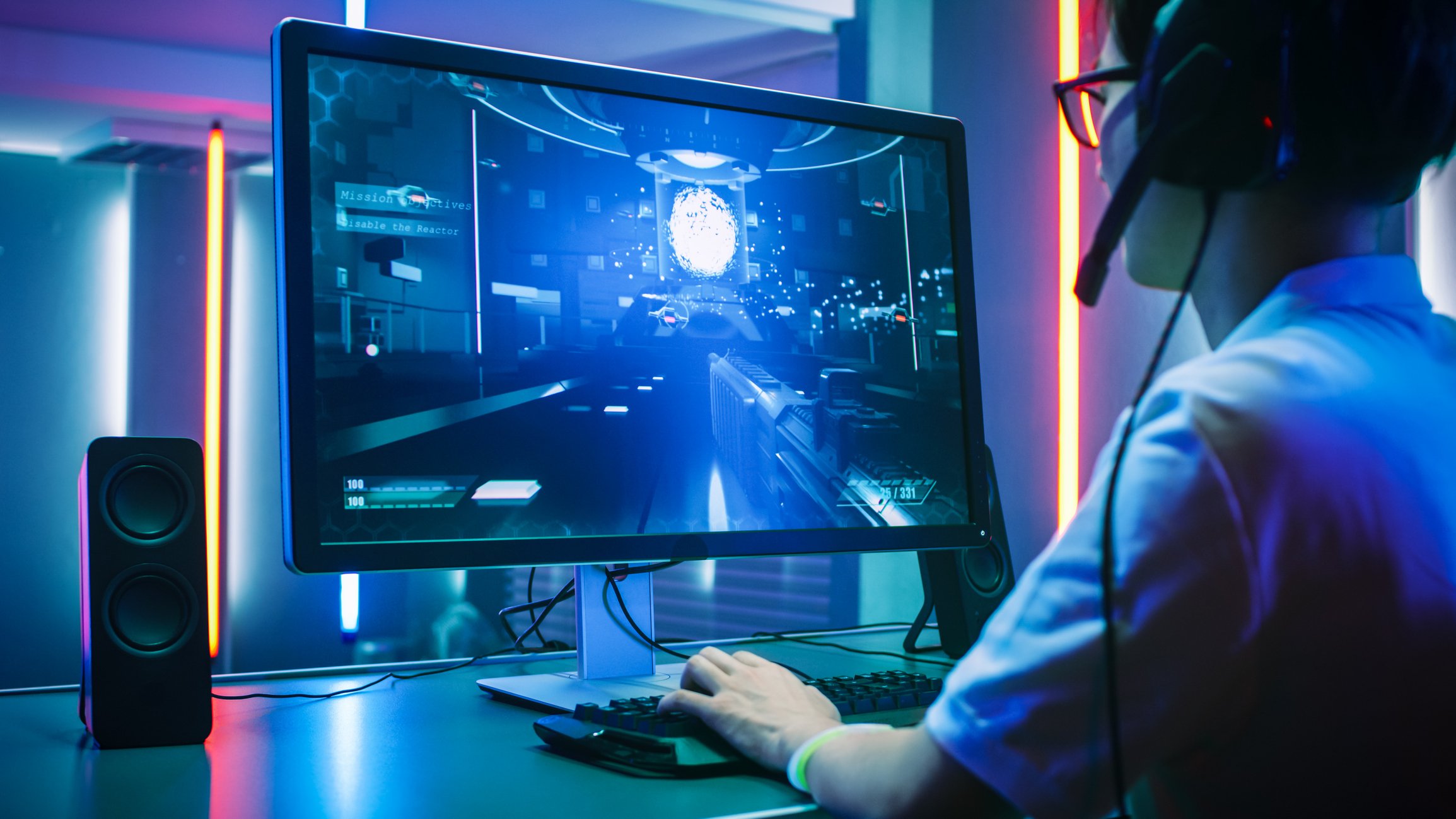 A person wearing a headset and playing a video game on a PC