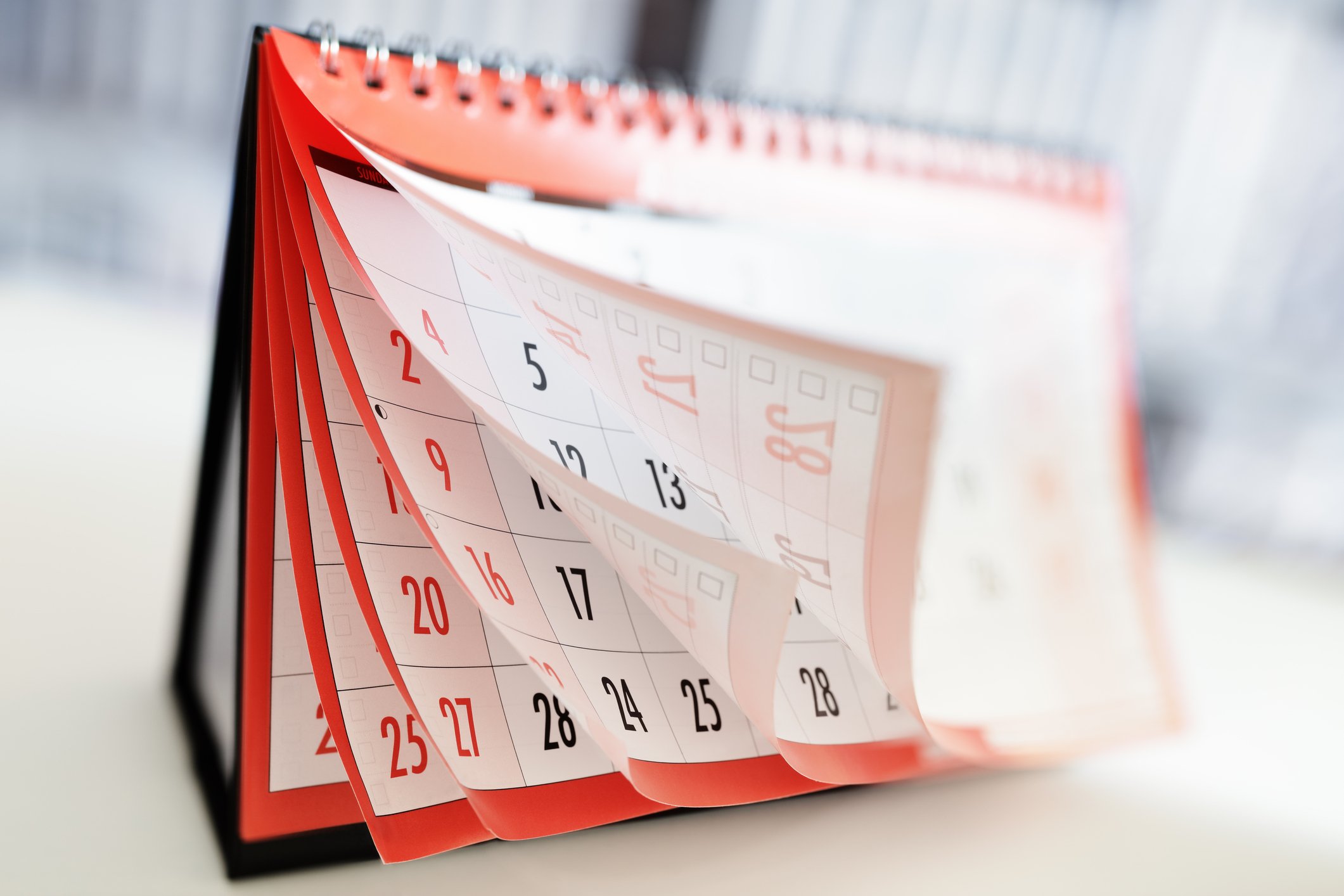 Red calendar with pages flying forward.