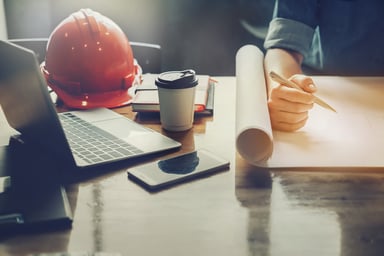 architect with plans on a desk