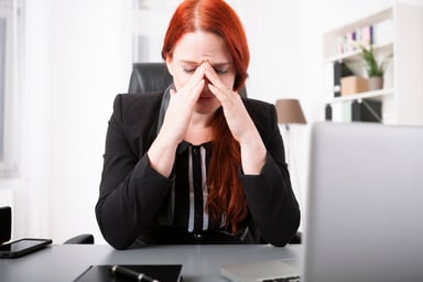 Woman crying at desk_GettyImages-527635617