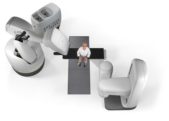 Accuray CyberKnife system with a man sitting in the middle