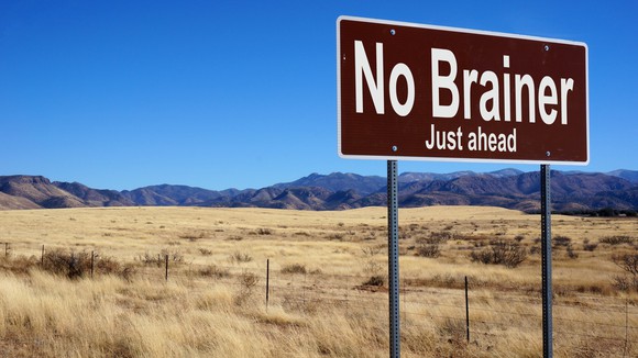 A brown highway sign that says the words no brainer just ahead.