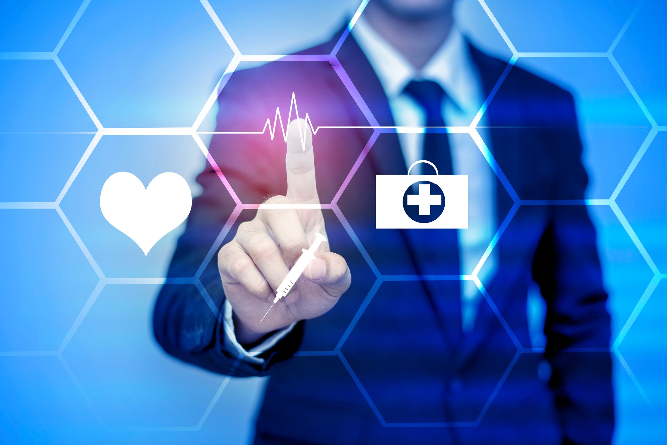 Businessman pointing to healthcare icons.