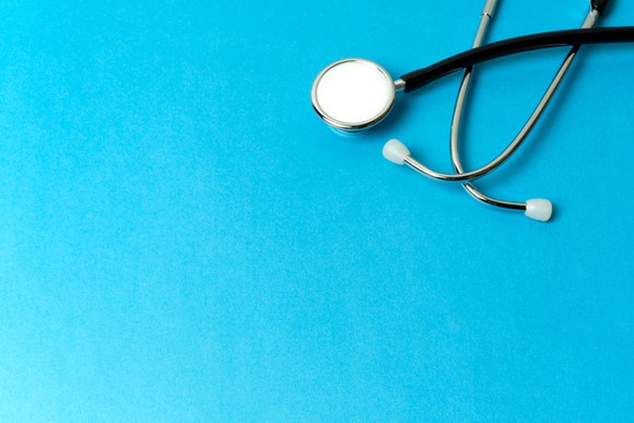 A stethoscope on a blue background.