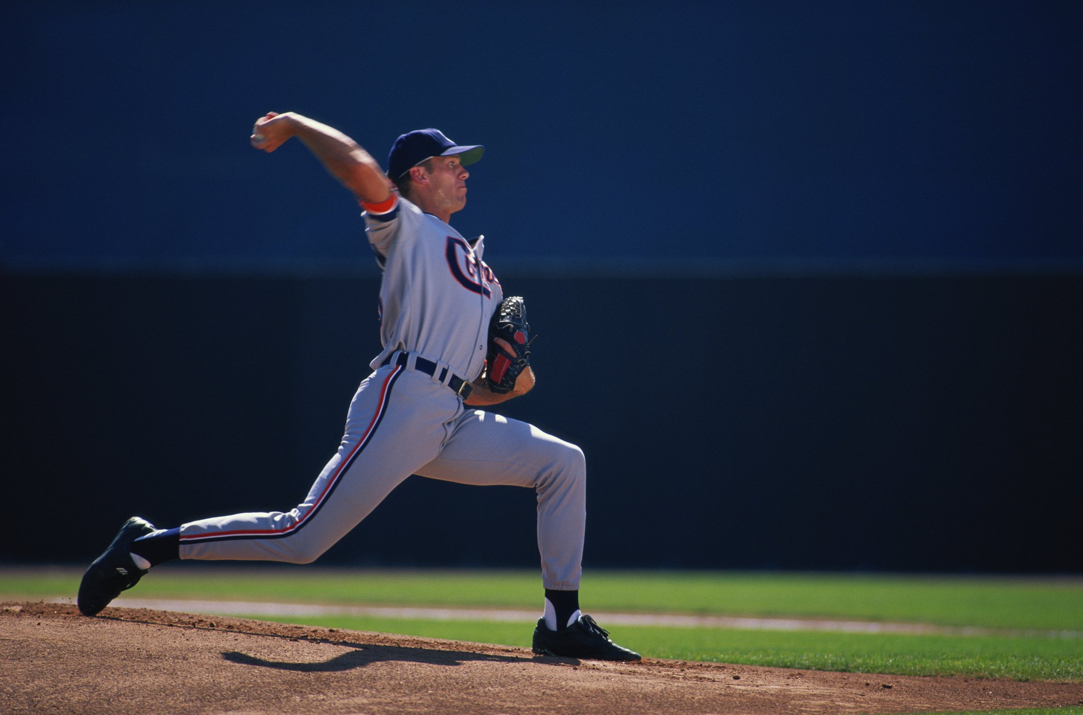 Pitcher throwing a baseball.