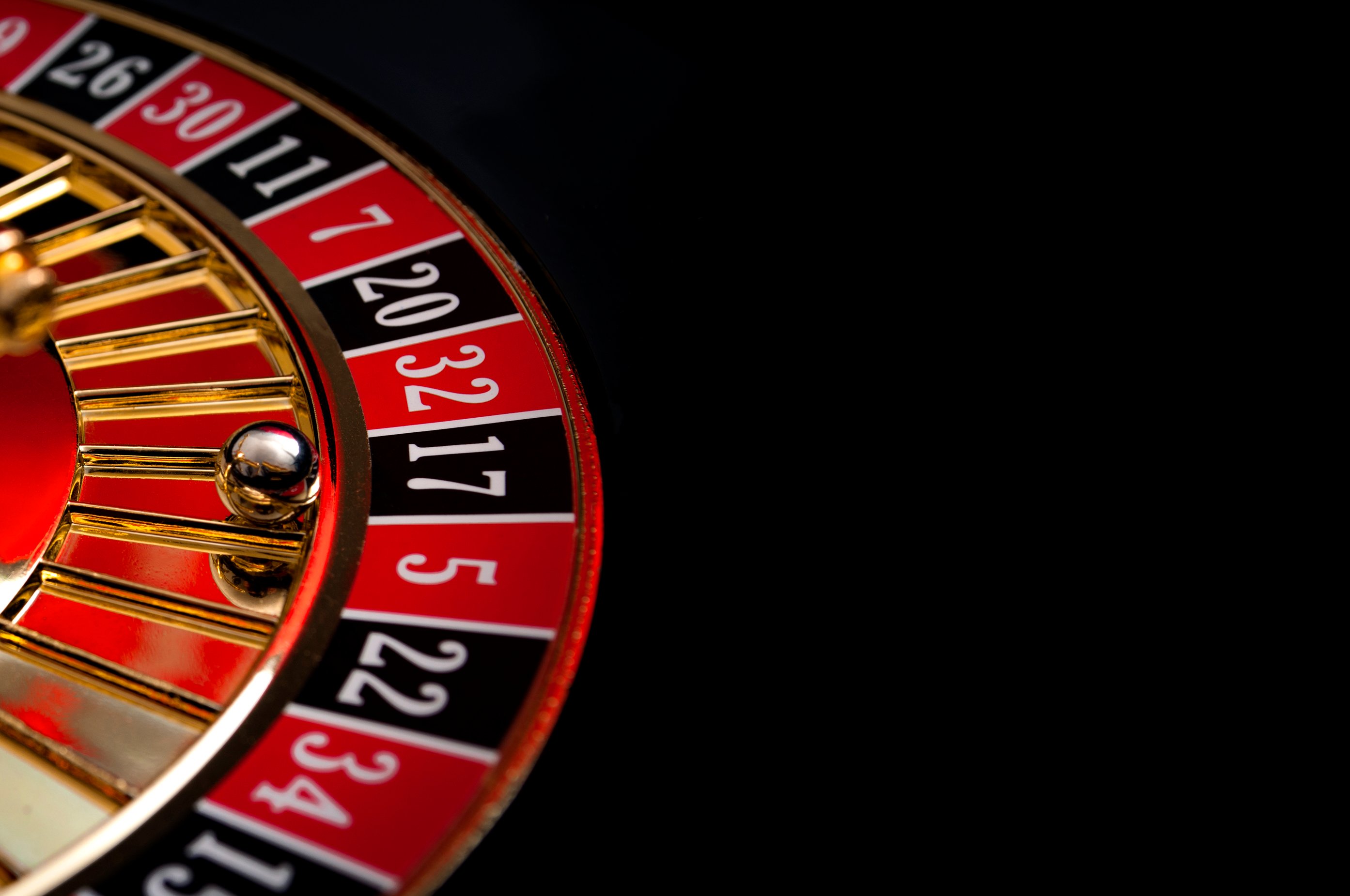 A roulette wheel on a black background